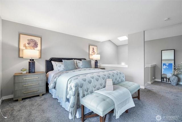 bedroom with a skylight, baseboards, and carpet flooring