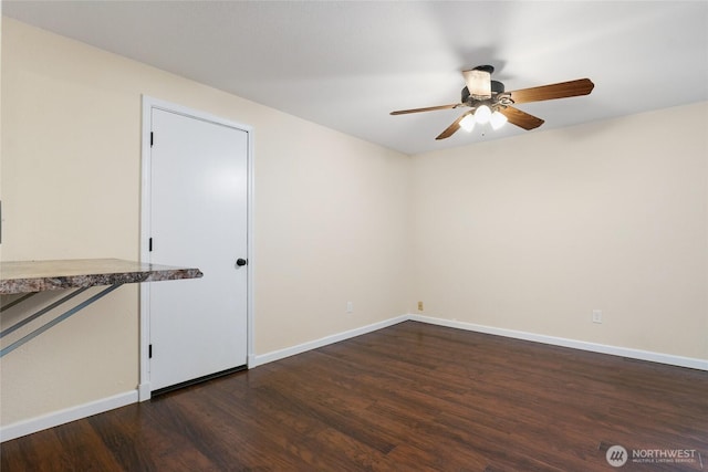 empty room with baseboards, ceiling fan, and wood finished floors