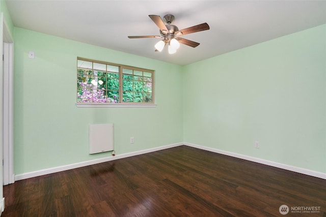 unfurnished room with a ceiling fan, baseboards, and wood finished floors