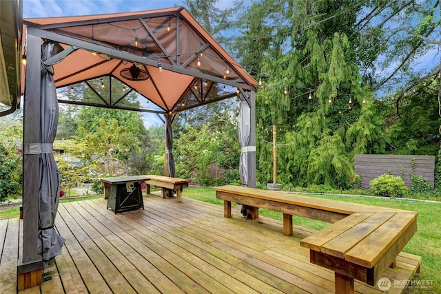 deck featuring a gazebo and an outdoor fire pit