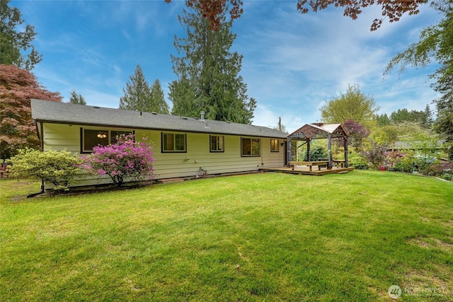 back of house with a lawn and a gazebo
