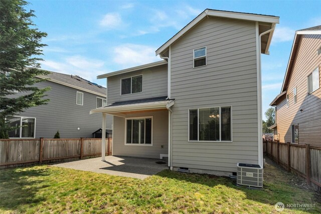 back of house featuring a yard, cooling unit, a fenced backyard, and a patio area