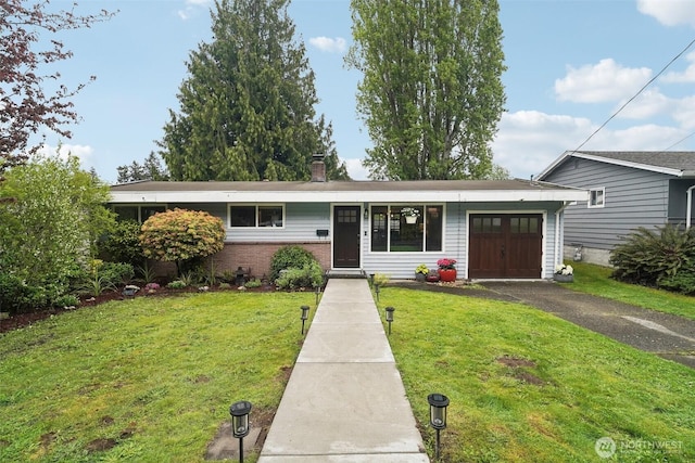 ranch-style home featuring an attached garage, driveway, a front lawn, a chimney, and brick siding