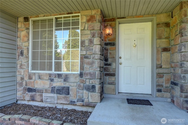 entrance to property with stone siding