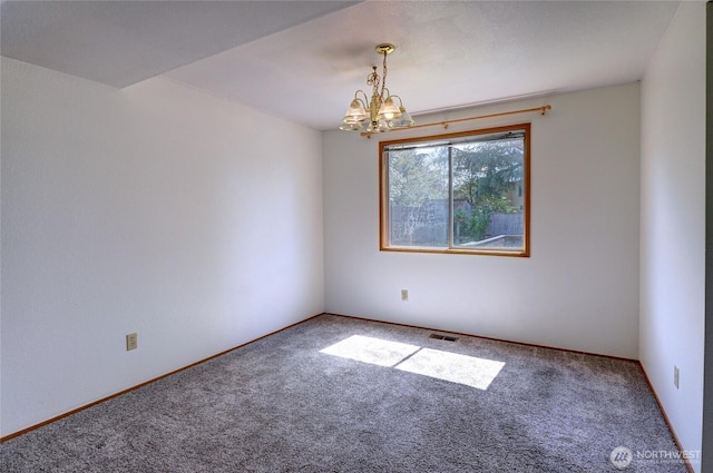 empty room featuring carpet floors, baseboards, a notable chandelier, and visible vents