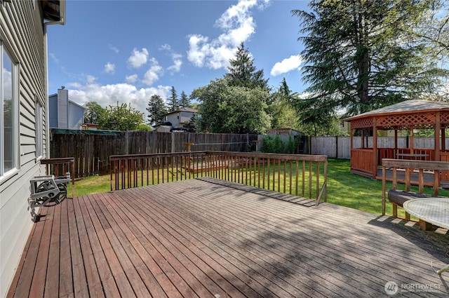 deck with a lawn, a gazebo, and a fenced backyard