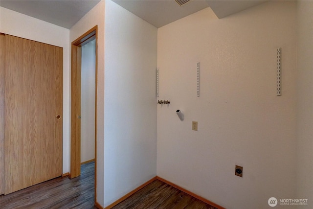 laundry room featuring baseboards, hookup for an electric dryer, laundry area, and dark wood-type flooring