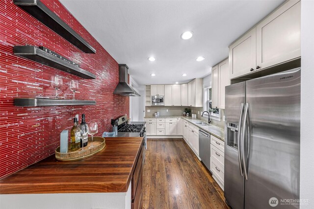 1626 106th Ave SE, Bellevue, WA 98004 - kitchen featuring a sink, white cabinetry, wall chimney exhaust hood, dark wood-type flooring, and stainless steel appliances
