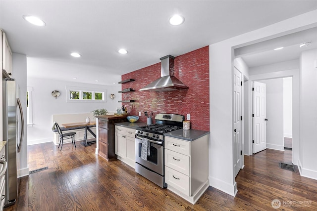1626 106th Ave SE, Bellevue, WA 98004 - kitchen with dark countertops, stainless steel appliances, dark wood-style flooring, wall chimney range hood, and recessed lighting