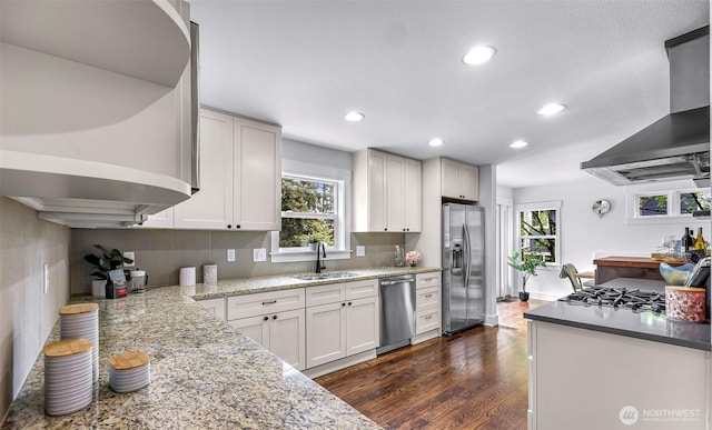1626 106th Ave SE, Bellevue, WA 98004 - kitchen featuring a sink, stainless steel appliances, wall chimney range hood, and plenty of natural light