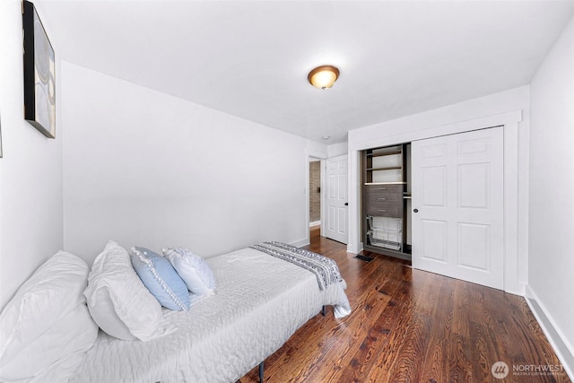 1626 106th Ave SE, Bellevue, WA 98004 - bedroom featuring baseboards, a closet, and wood finished floors
