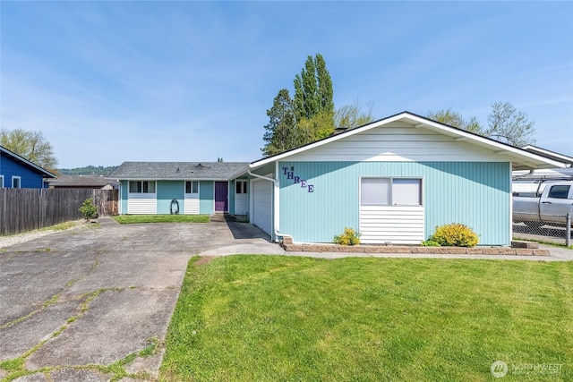 single story home featuring fence, a garage, driveway, and a front yard