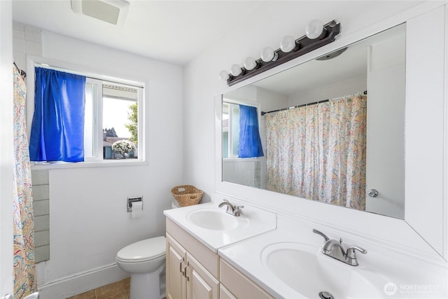 bathroom with double vanity, toilet, a shower with shower curtain, and a sink