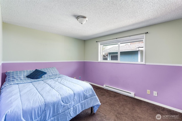 bedroom featuring a textured ceiling, a baseboard heating unit, baseboards, and carpet