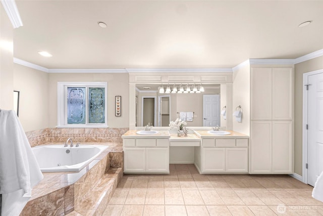 bathroom with a tub with jets, a sink, tile patterned floors, and ornamental molding