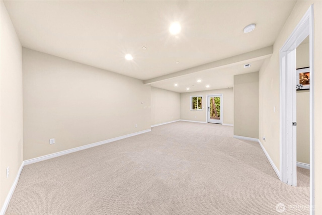 spare room with recessed lighting, baseboards, and light carpet