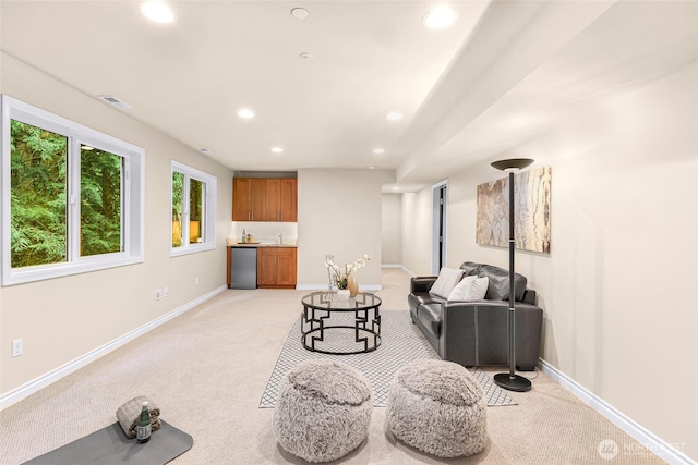 living room with recessed lighting, baseboards, visible vents, and light carpet