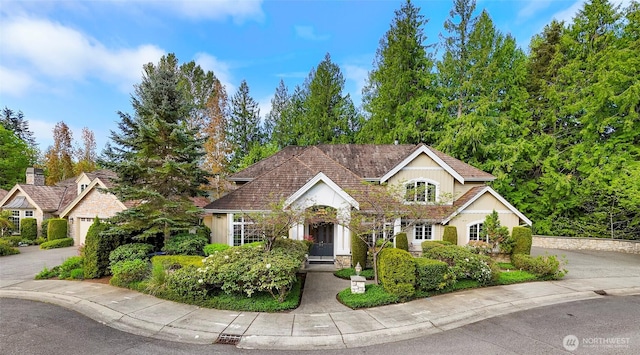 view of front facade featuring driveway and stone siding