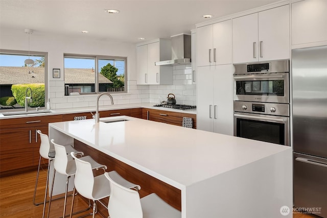 6614 N 49th St, Tacoma, WA 98407 - kitchen featuring a sink, light countertops, wall chimney range hood, and stainless steel appliances