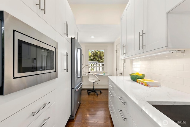 514 30th Ave E, Seattle, WA 98112 - kitchen with decorative backsplash, dark wood-style flooring, stainless steel appliances, recessed lighting, and white cabinetry