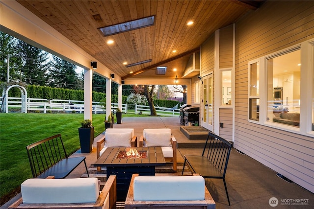 view of patio / terrace featuring an outdoor living space with a fire pit and fence