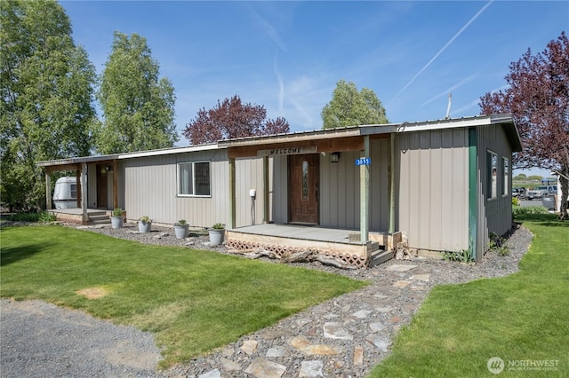 view of front of property with a porch and a front lawn
