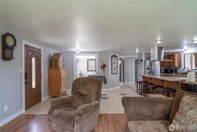 living room with light tile patterned floors and baseboards