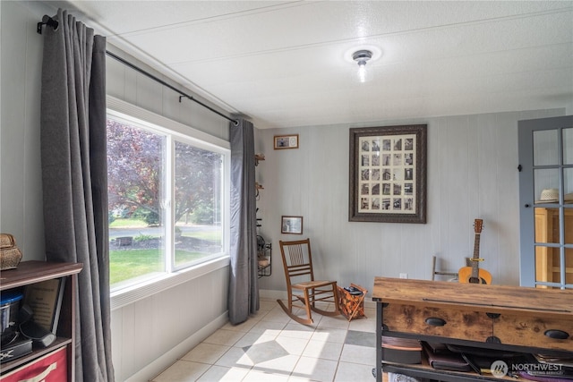 interior space featuring light tile patterned floors and baseboards