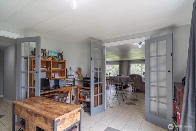 home office with light tile patterned floors and french doors