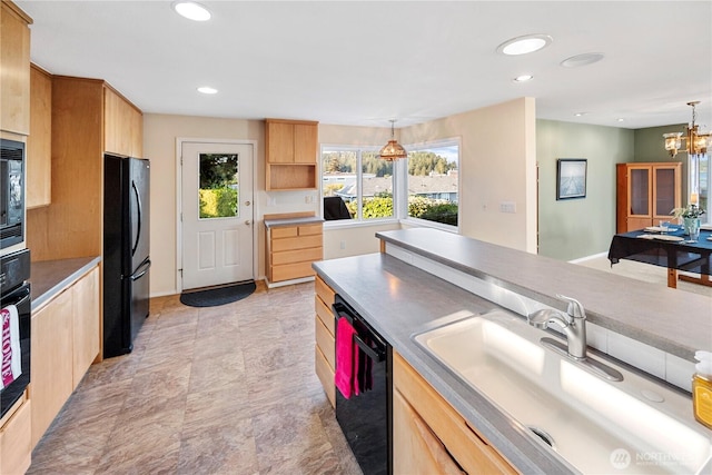 kitchen featuring hanging light fixtures, a sink, black appliances, light brown cabinets, and recessed lighting