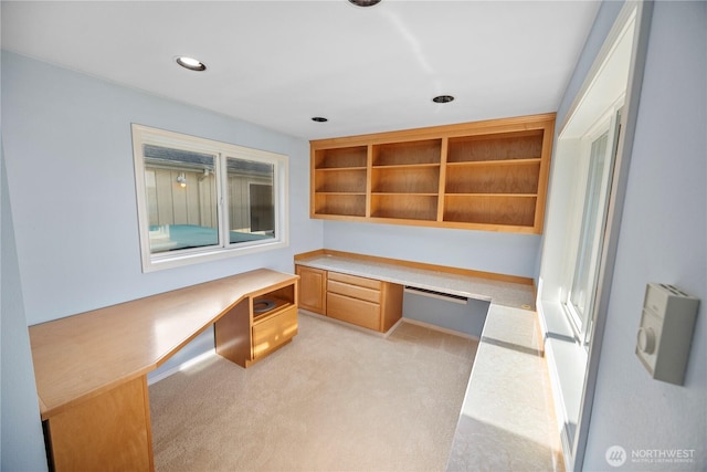 unfurnished office with built in study area, light carpet, and recessed lighting