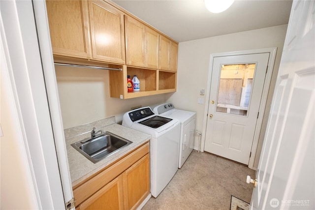 laundry area with a sink, cabinet space, and washer and clothes dryer