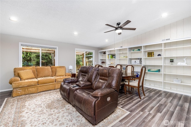 living room featuring recessed lighting, ceiling fan, vaulted ceiling, a textured ceiling, and wood finished floors