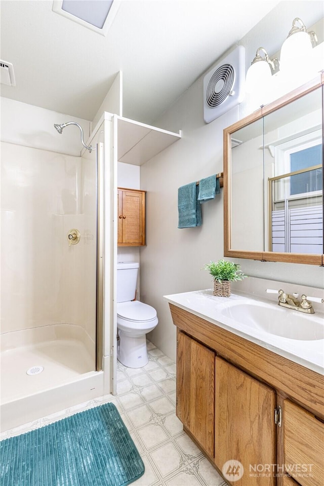 full bathroom featuring tile patterned floors, visible vents, toilet, and a stall shower
