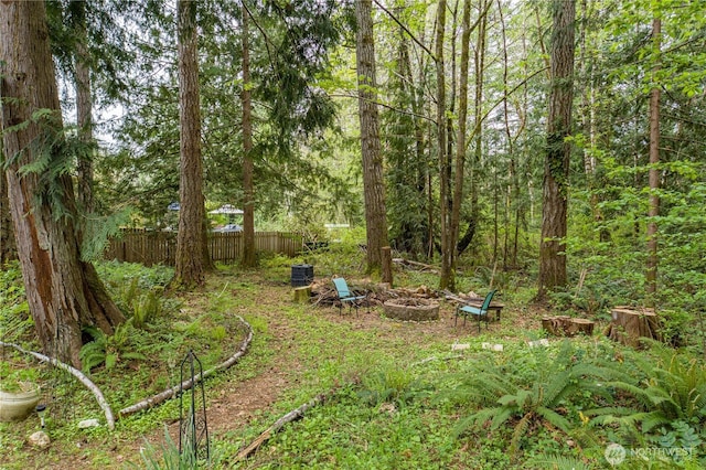 view of yard featuring fence and a fire pit