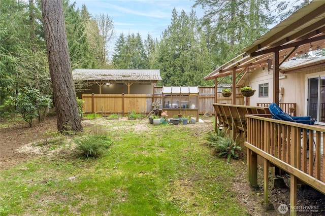 view of yard with fence and a deck