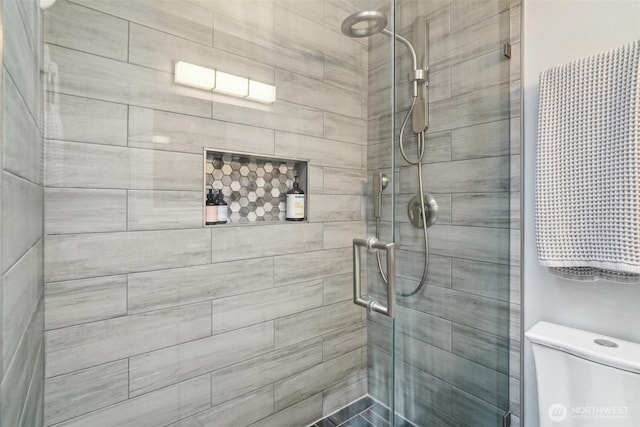 full bathroom with toilet and a shower stall