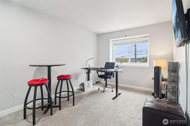 carpeted home office with baseboards