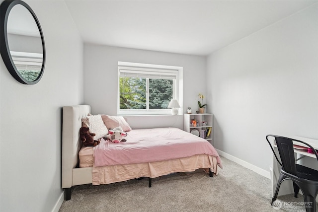 bedroom with baseboards and carpet