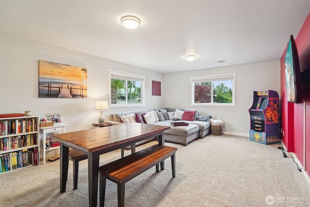 living area featuring visible vents, carpet flooring, and baseboards
