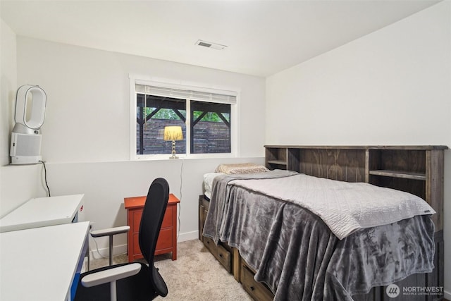 bedroom featuring visible vents, baseboards, and light carpet