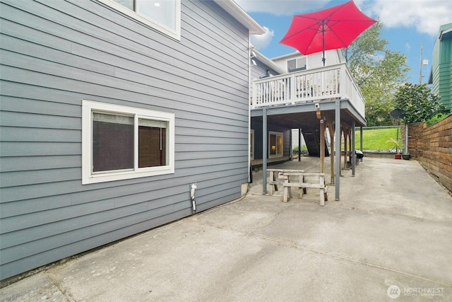 back of house featuring fence, a patio area, and a deck