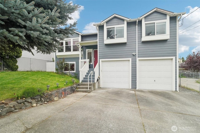 raised ranch featuring an attached garage, a front lawn, fence, and concrete driveway