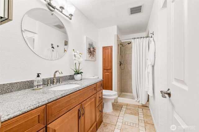 full bath featuring visible vents, tile patterned flooring, a shower stall, vanity, and toilet