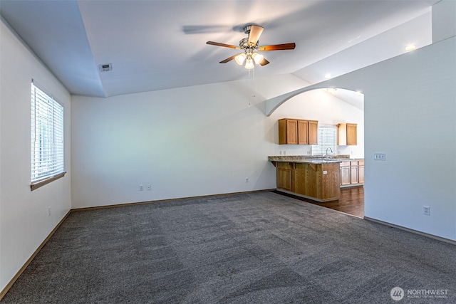 8342 49th Loop SE, Olympia, WA 98513 - unfurnished living room featuring plenty of natural light, visible vents, lofted ceiling, and dark carpet