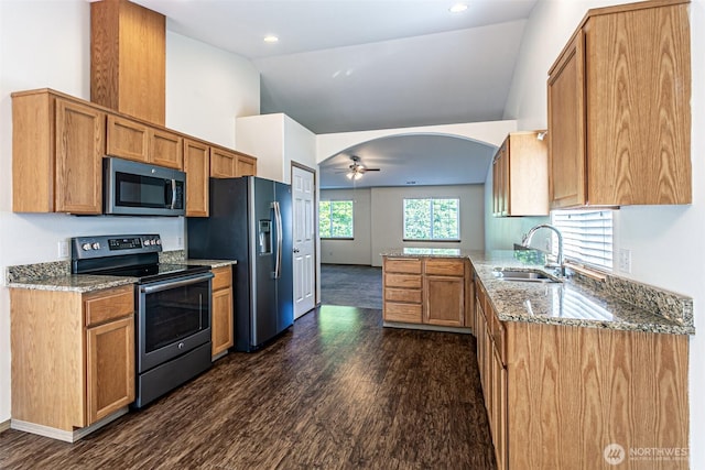 8342 49th Loop SE, Olympia, WA 98513 - kitchen featuring light stone counters, a sink, vaulted ceiling, appliances with stainless steel finishes, and dark wood-style floors