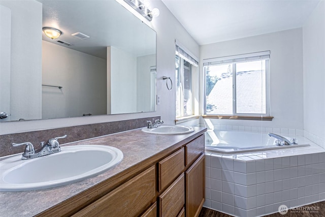 8342 49th Loop SE, Olympia, WA 98513 - full bathroom featuring a garden tub, visible vents, a sink, and double vanity