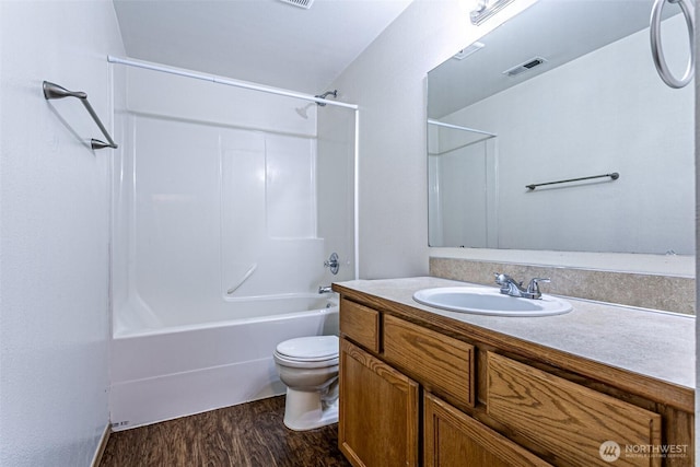 8342 49th Loop SE, Olympia, WA 98513 - bathroom featuring toilet, wood finished floors, vanity, visible vents, and bathing tub / shower combination