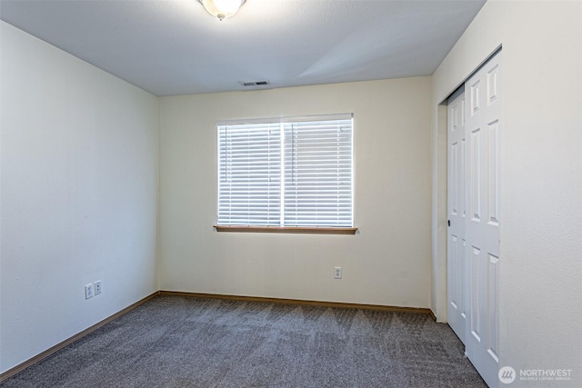 8342 49th Loop SE, Olympia, WA 98513 - unfurnished bedroom with carpet flooring, a closet, visible vents, and baseboards