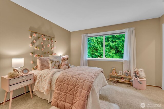 carpeted bedroom featuring baseboards